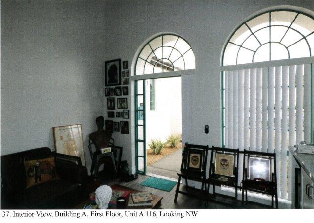 After: Interior view of apartment facing north showing a modified arched door entrance and retained arched window opening.